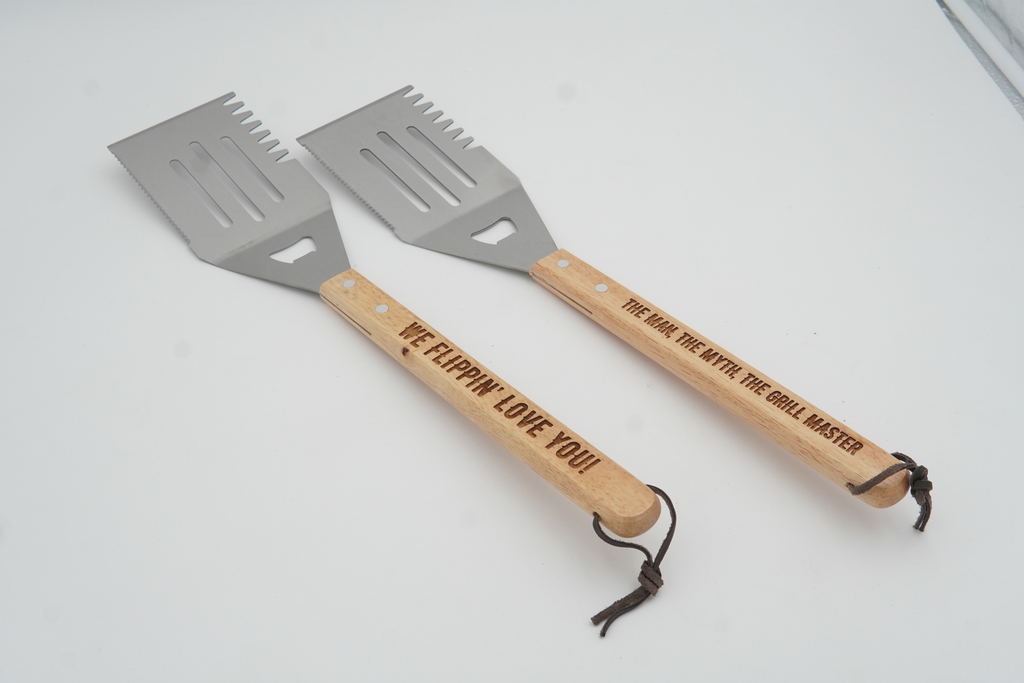 Two spatulas with wooden handles on a white background
