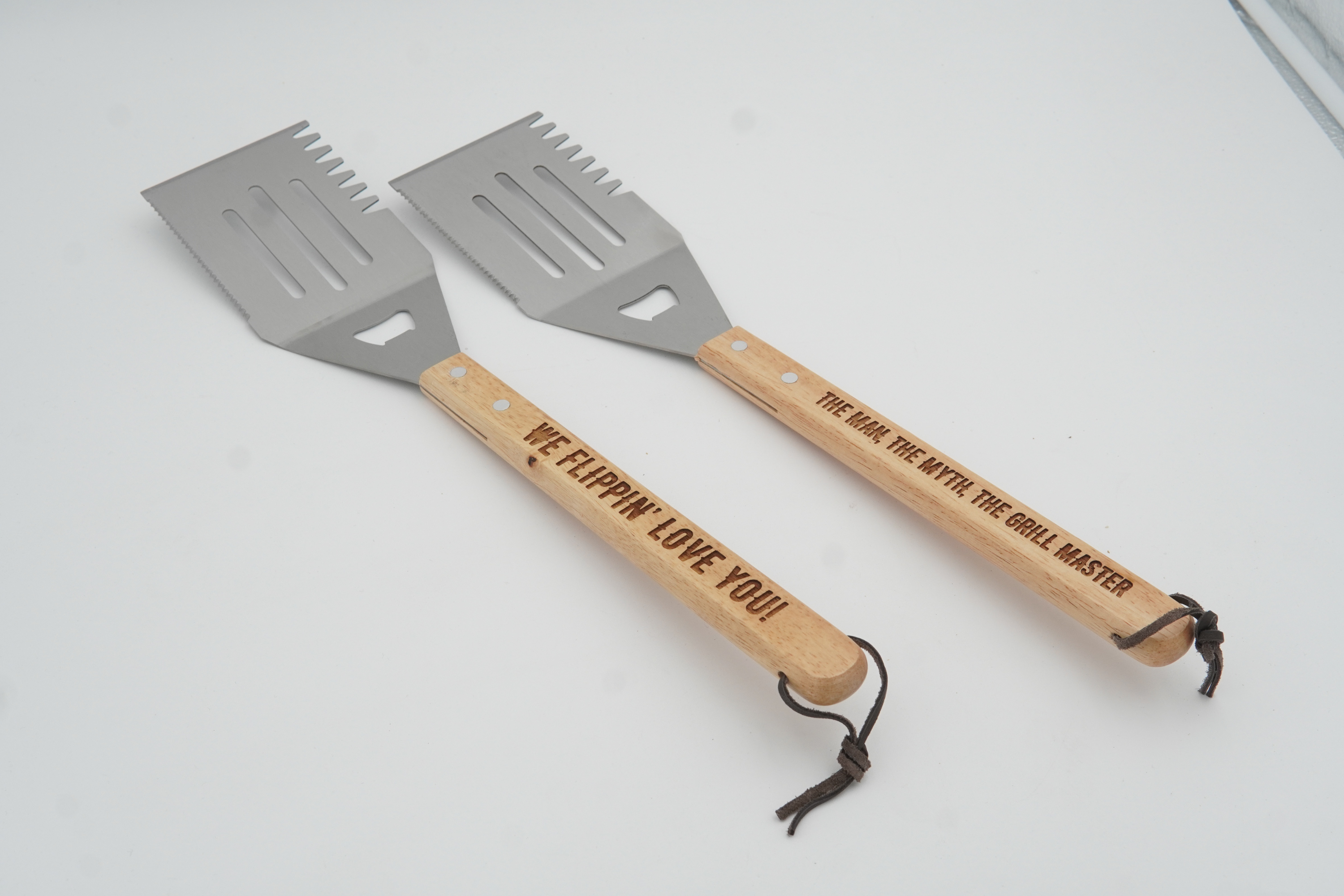 Two spatulas with wooden handles on a white background